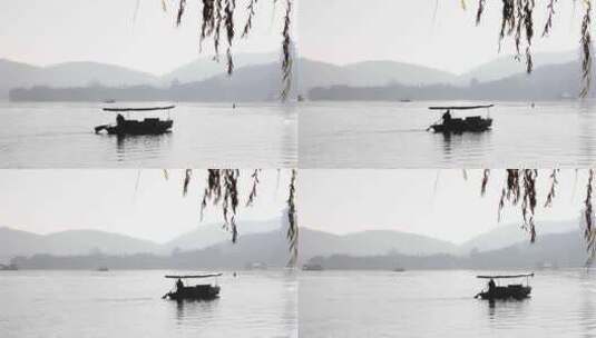 杭州西湖湖面游船手划船晨曦高清在线视频素材下载
