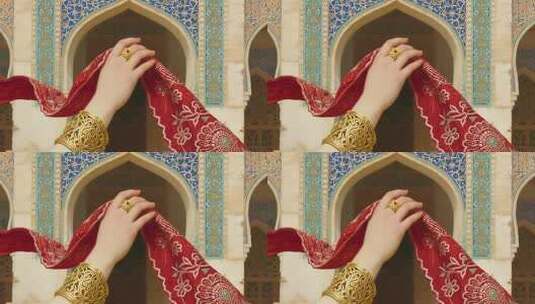 手戴金饰持红布于伊斯兰建筑前高清在线视频素材下载