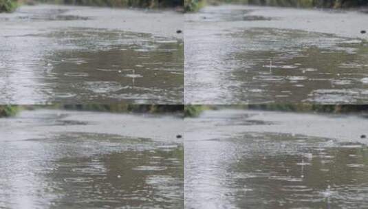 雨水落在地上的水坑上溅起水花高清在线视频素材下载