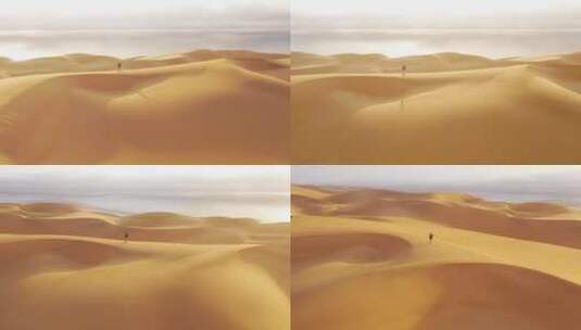 一个站在纳米比亚纳米布沙漠美丽沙丘上的女模特高清在线视频素材下载