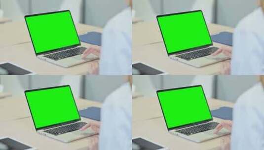 在带有绿色屏幕的笔记本电脑上工作的人高清在线视频素材下载