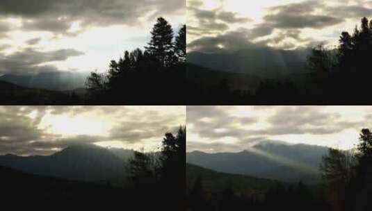阳光穿过云层飘动丁达尔光山顶山脉晚霞落日高清在线视频素材下载