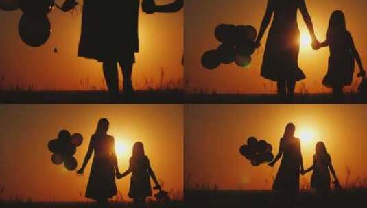 妈妈和女儿在日落时散步气球和泰迪熊被携带高清在线视频素材下载