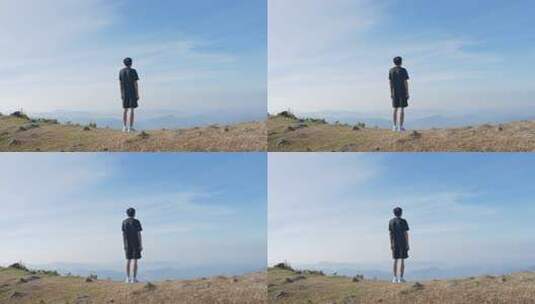 男子山顶眺望远方山峦高清在线视频素材下载