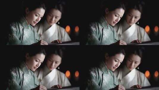 古代女子烛光下专注书写绘画高清在线视频素材下载