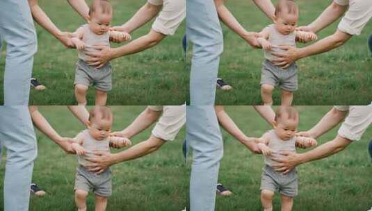 成人辅助婴儿草地学步高清在线视频素材下载