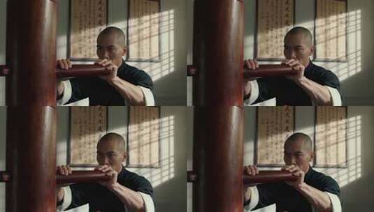 男子练习咏春拳打木人桩高清在线视频素材下载