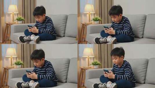 男孩坐在沙发上玩手机高清在线视频素材下载