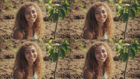 她面带微笑在土地上栽种新生命高清在线视频素材下载