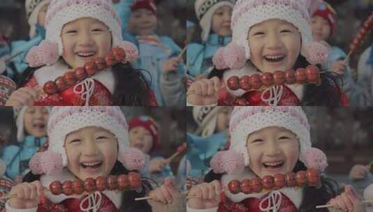 拿着糖葫芦面对着镜头微笑的女孩高清在线视频素材下载