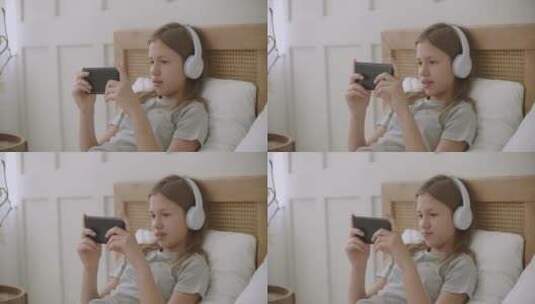 女孩在床上玩智能手机高清在线视频素材下载