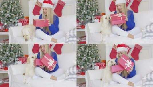 女孩戴着圣诞帽拆圣诞节礼物高清在线视频素材下载