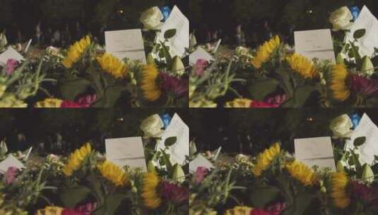 绿色公园花卉贡品和哀悼者特写镜头高清在线视频素材下载