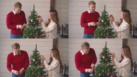 夫妇在家里的圣诞树上悬挂圣诞装饰高清在线视频素材下载