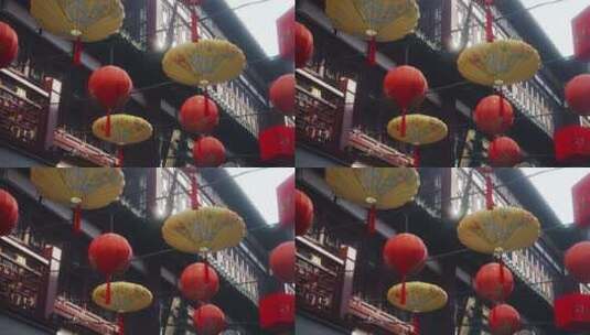 过年春节挂在古楼间的灯笼和红伞高清在线视频素材下载