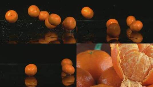 实拍黑色背景下橘子滚落特写高清在线视频素材下载