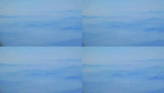 飞机窗外云雾中重峦叠嶂的山峦高清在线视频素材下载