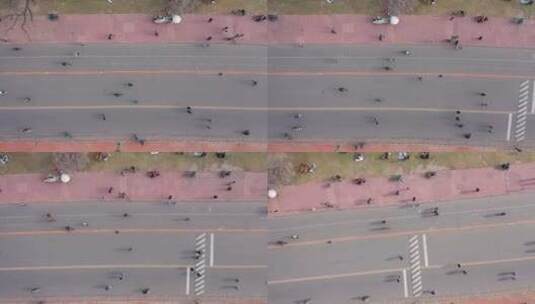 在有自行车道的人行道上进行运动的人群的空高清在线视频素材下载