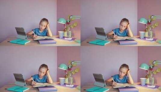 疲惫的女孩坐在书桌前写作业高清在线视频素材下载