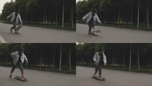 一位女生在校园道路上练习滑板运动高清在线视频素材下载