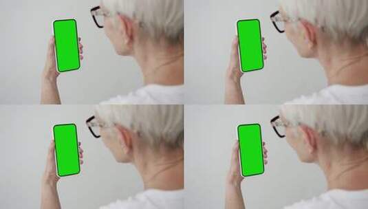 老人使用绿幕智能手机在视频通话高清在线视频素材下载