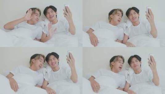 亚洲帅哥同性恋早上在家里与家人在线使用手机视频通话。高清在线视频素材下载