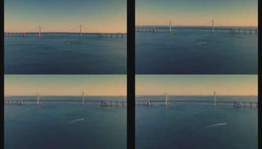 大连航拍海边跨海湾大桥唯美岩壁大海夕阳高清在线视频素材下载