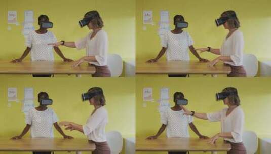 两个不同的女同事站在办公桌前，测试虚拟现实谷歌高清在线视频素材下载