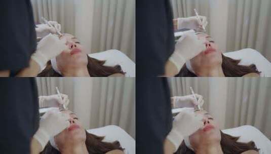 美容师用笔在病人额头上标记肉毒杆菌的注射高清在线视频素材下载