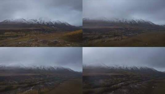 新疆阿勒泰禾木古村落雪山秋色航拍高清在线视频素材下载