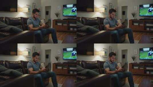 男子沙发上看电视玩手机高清在线视频素材下载