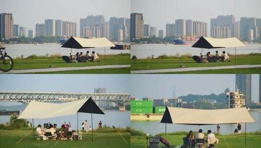 南京长江边滨江公园草地游客户外露营场景高清在线视频素材下载