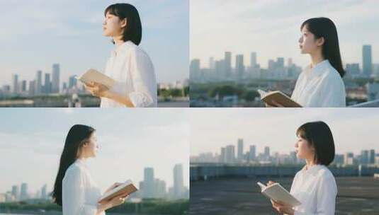 女子户外手持笔记本眺望远方高清在线视频素材下载