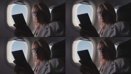 商务女性在飞机上阅读电子书高清在线视频素材下载