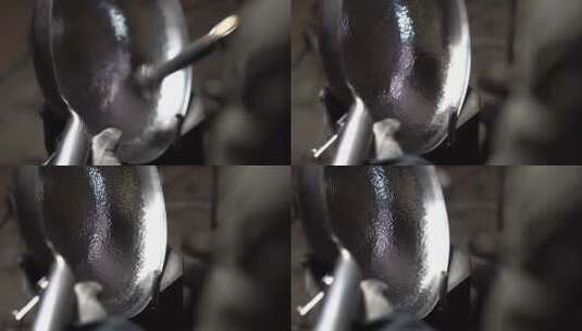 章丘铁锅，工匠师傅正在用锤手工锻造铁锅高清在线视频素材下载