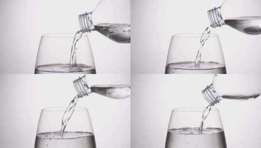 从塑料瓶将水倒入玻璃杯高清在线视频素材下载