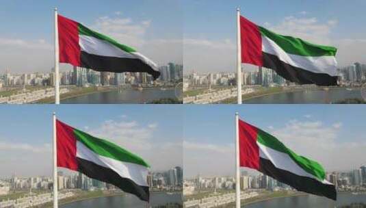 鸟瞰图：阿联酋沙迦国旗岛上空挥舞的阿拉伯联合酋长国国旗高清在线视频素材下载
