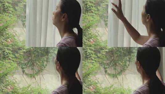 女性居家眺望窗外景色高清在线视频素材下载
