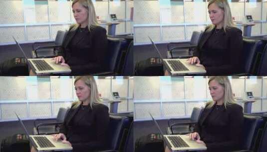 女商人在机场使用笔记本电脑高清在线视频素材下载