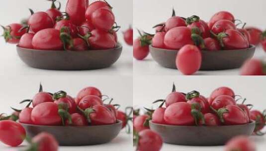 慢镜头特写拍摄落到碗中的新鲜有机小番茄高清在线视频素材下载