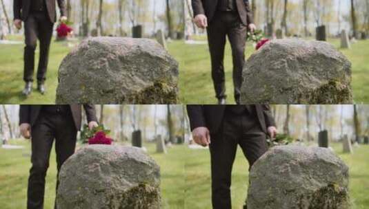 将鲜花放在墓碑上的男人高清在线视频素材下载