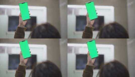 女性居家使用绿色屏幕绿屏抠像替换屏幕手机高清在线视频素材下载