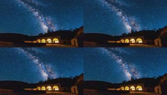 夜空下带灯光建筑的星空景象高清在线视频素材下载