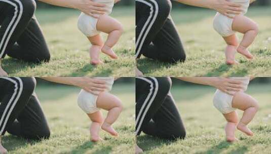 母亲辅助婴儿草地学步高清在线视频素材下载