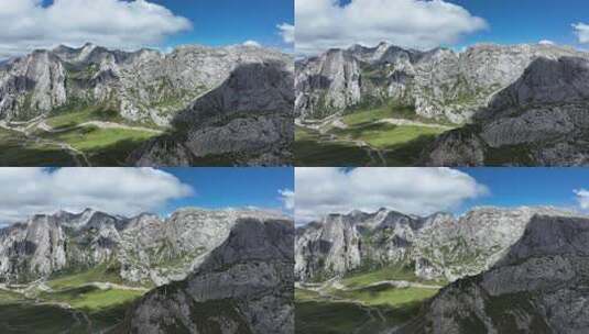 蓝天白云下甘南扎尕那的山脉和山谷中的公路高清在线视频素材下载