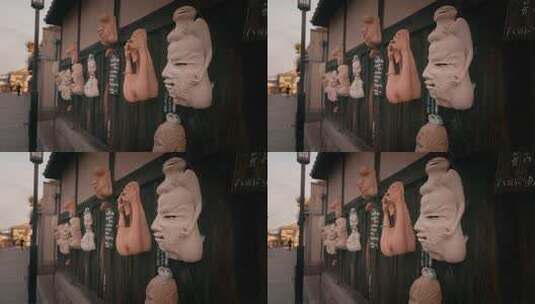 街道边墙上悬挂的特色面具高清在线视频素材下载