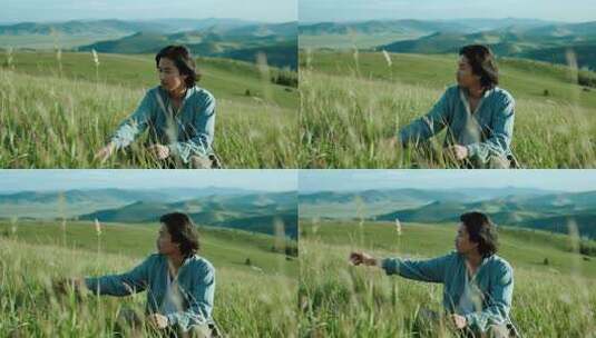 男子坐于草原草地眺望远方高清在线视频素材下载