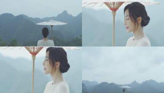 少女打着纸伞在山顶行走高清在线视频素材下载