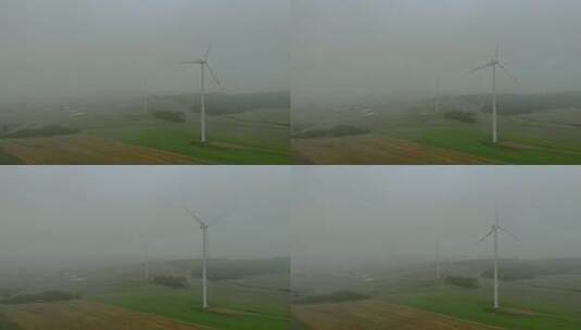 风力发电场雾蒙蒙的早晨，风车在田野里靠得很近，高清在线视频素材下载