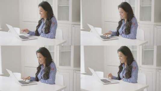 女人微笑着浏览笔记本电脑高清在线视频素材下载